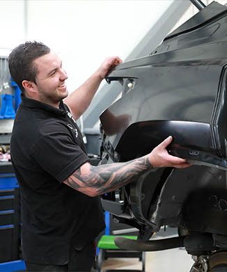 parramatta smash repair technician fitting side panel on car